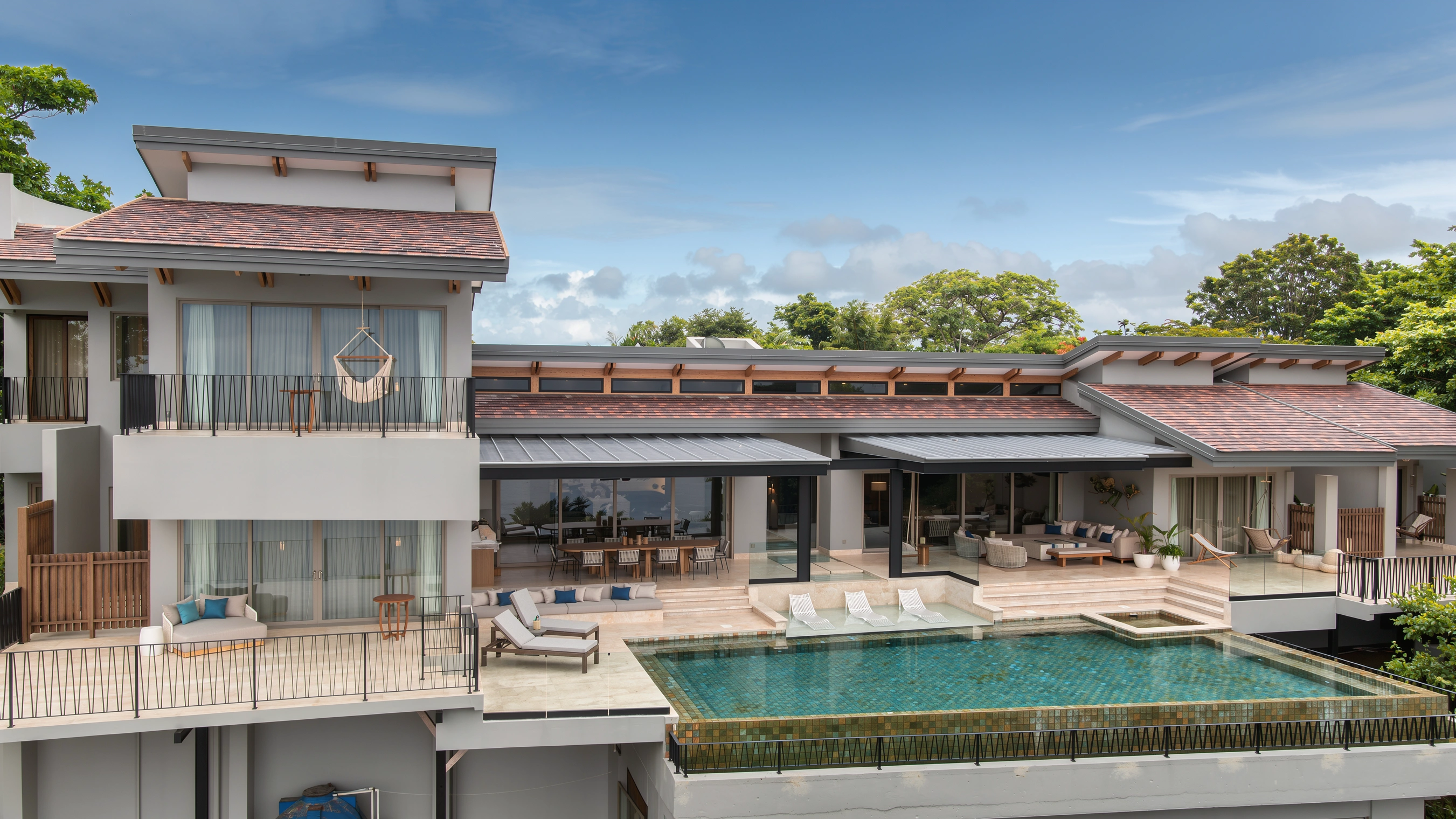 AI-enhanced photograph of the Coastal Retreat's pool terrace and ocean-facing living spaces