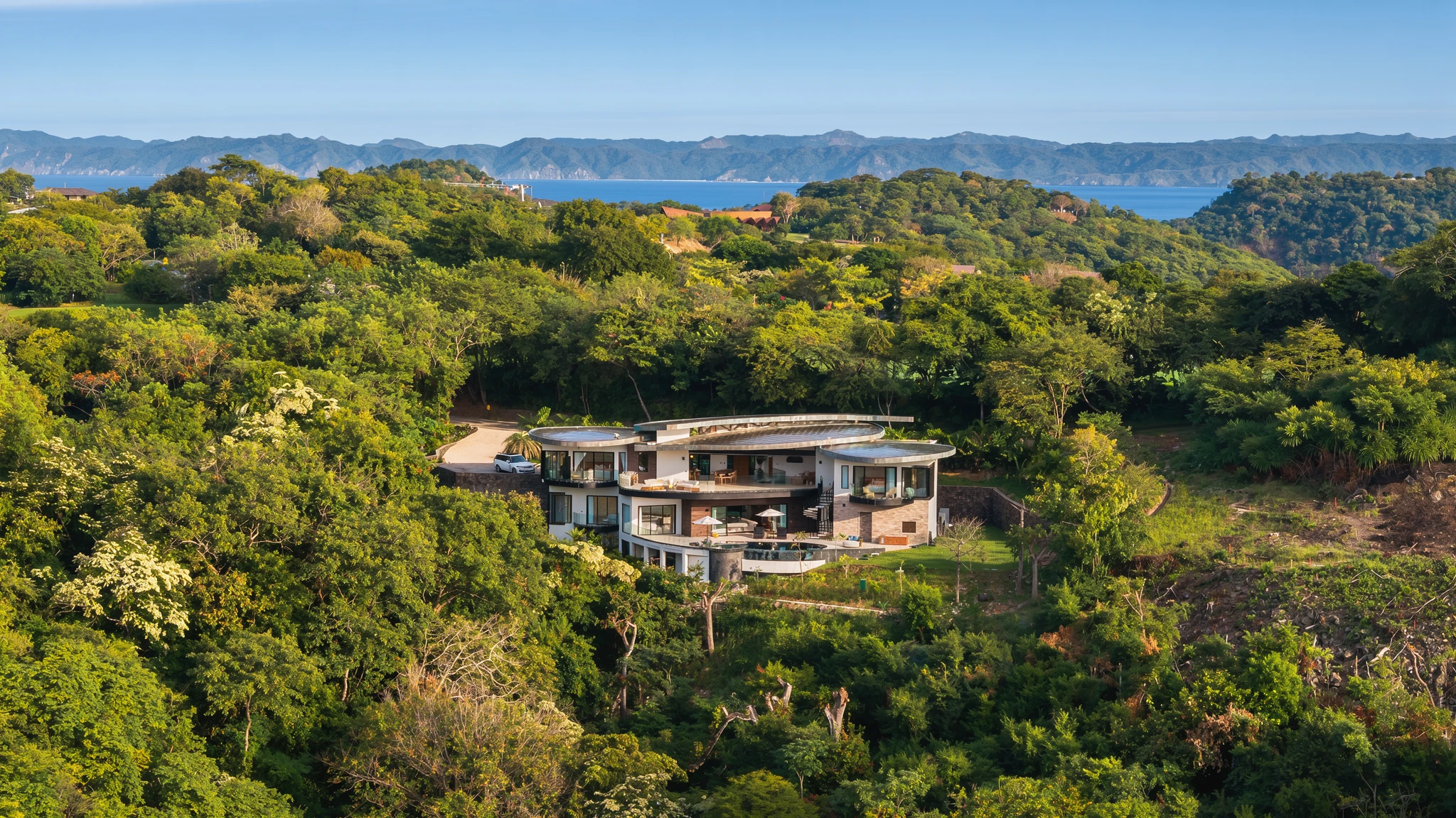 AI-enhanced photograph of Papagayo 6BR Contemporary Bayview Villa: architecture and forested coastline