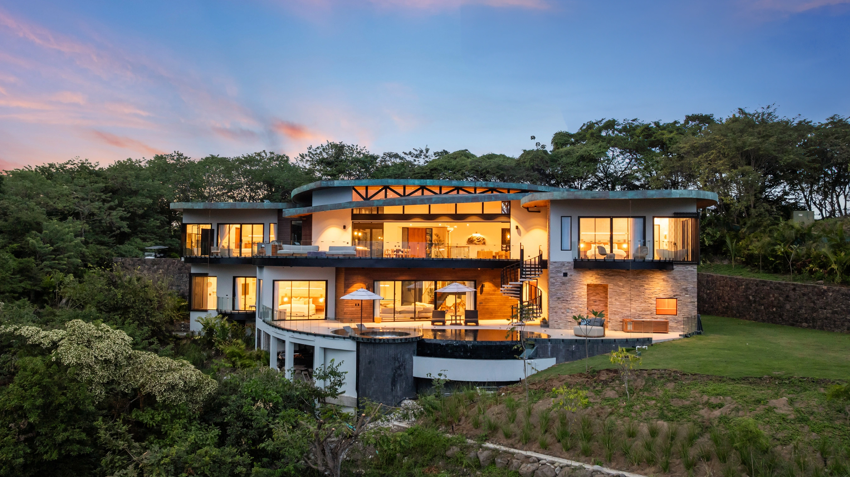 AI-enhanced photograph of the Contemporary Bayview Villa at dusk, with illuminated interiors and curving rooflines