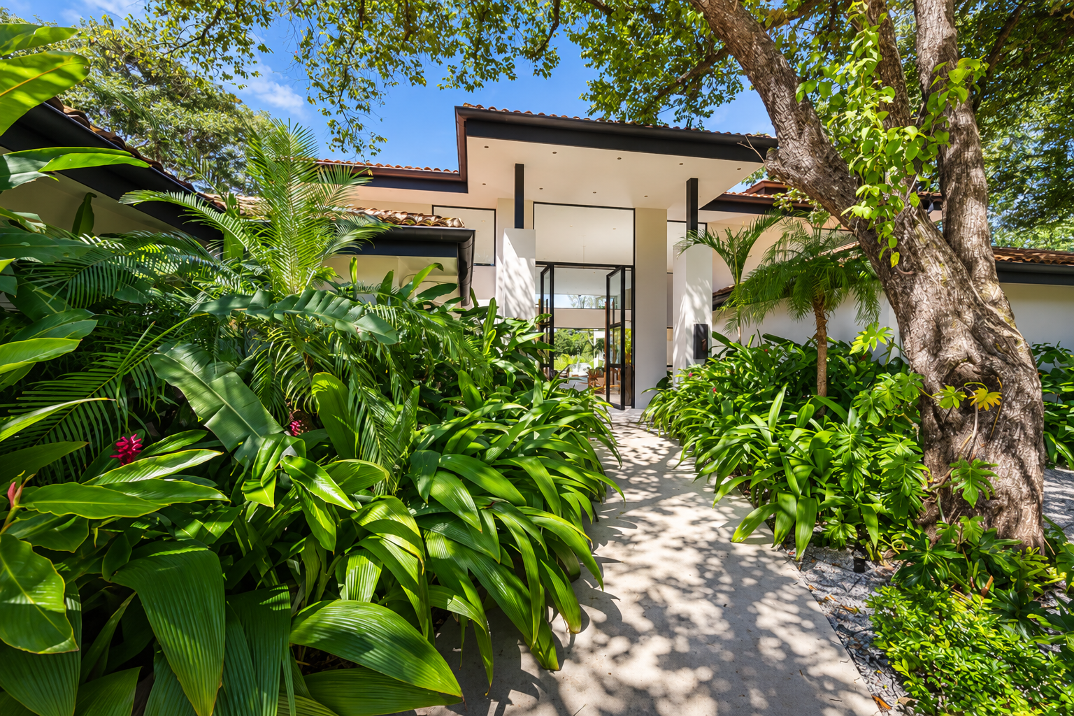 Hacienda Pinilla 7BR Golfside Villa entrance framed by tropical foliage