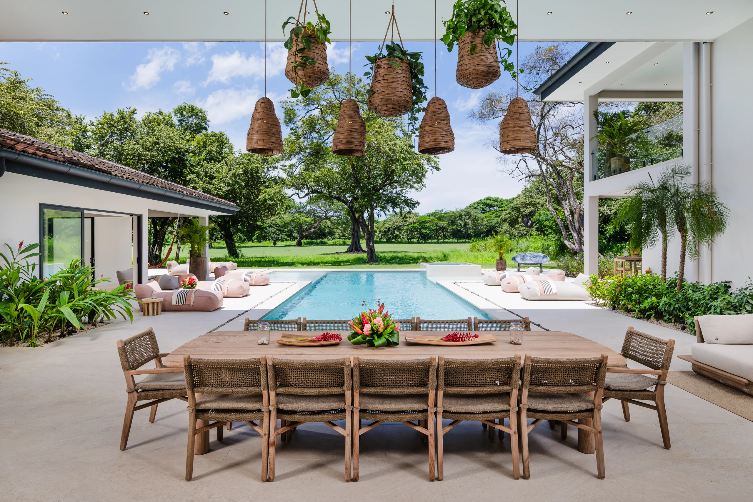 outdoor dining overlooking the private pool and garden